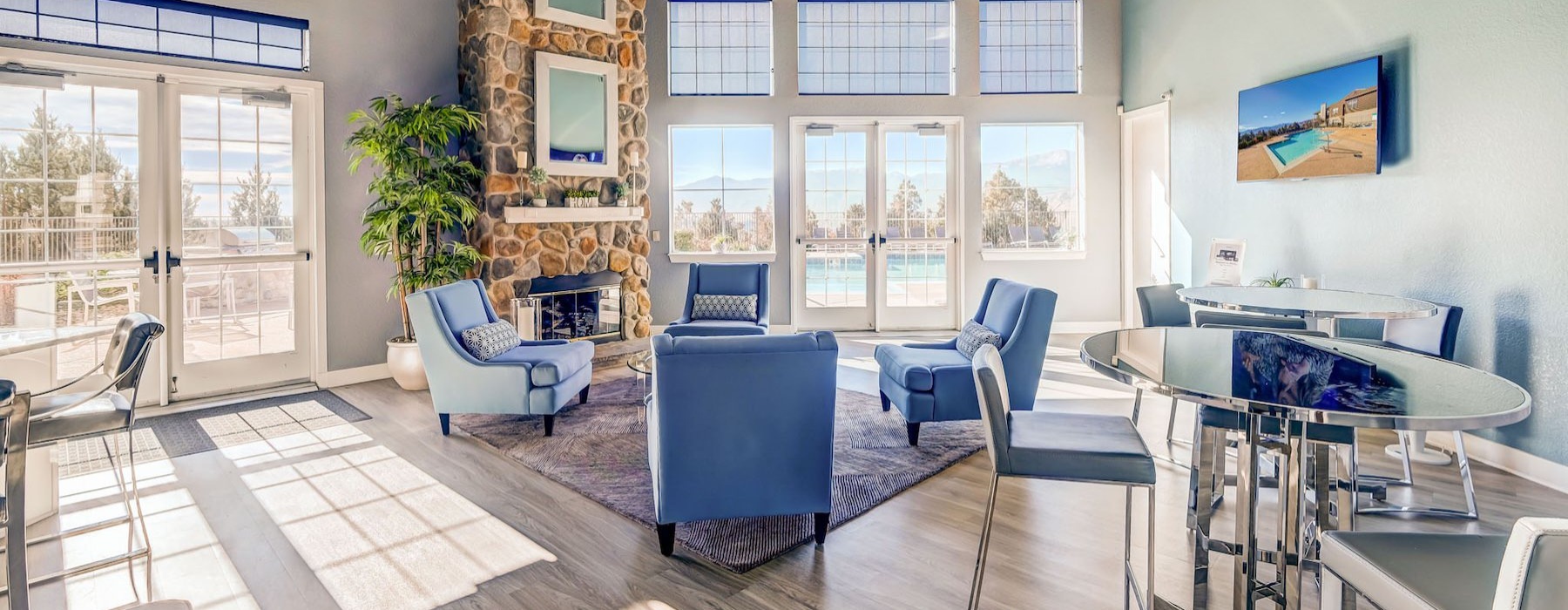 a clubroom with a tv, tables and chairs