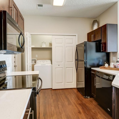 a kitchen with wood cabinets