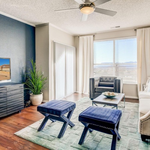 a living room with a tv, tables and chairs